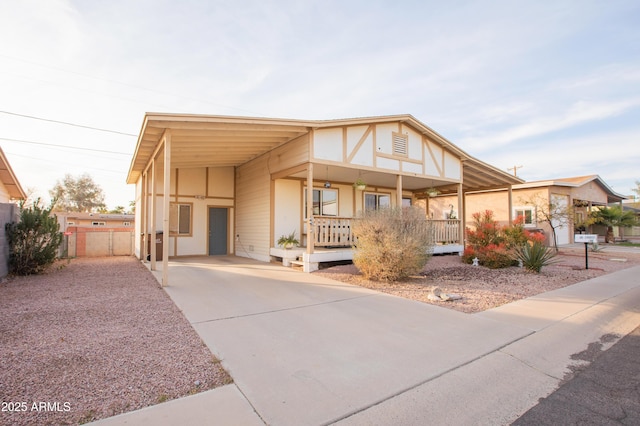 view of front of home featuring a carport and covered porch