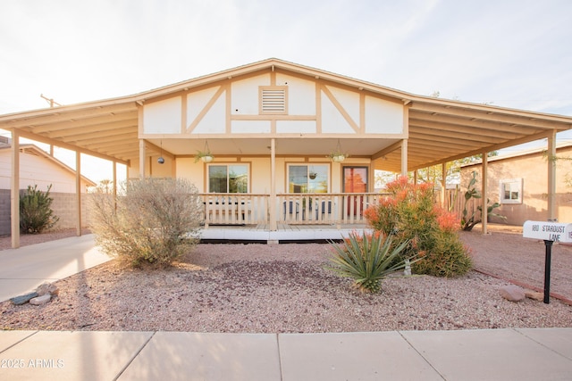 view of front of property featuring a carport and covered porch