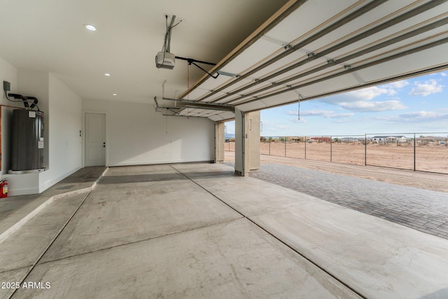 garage featuring a rural view, water heater, and a garage door opener