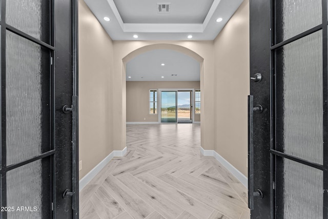 corridor featuring light parquet flooring