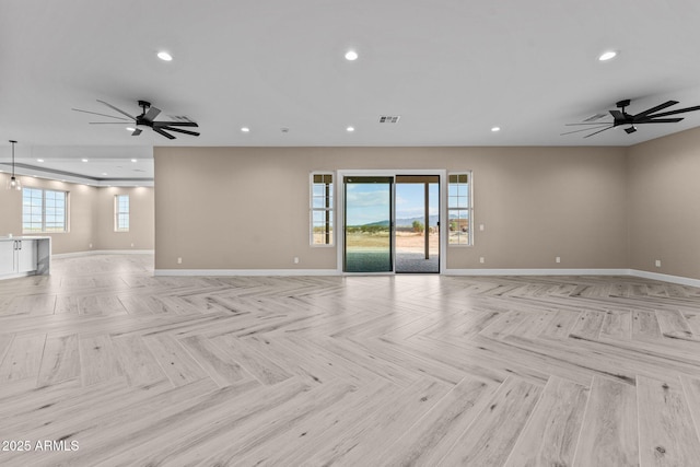 unfurnished living room featuring ceiling fan and light parquet flooring