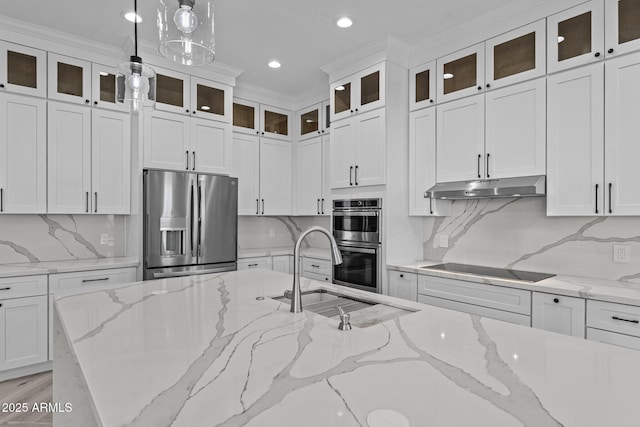 kitchen with white cabinetry, stainless steel appliances, tasteful backsplash, hanging light fixtures, and light stone counters