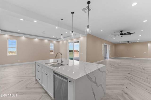 kitchen with light parquet flooring, dishwasher, sink, hanging light fixtures, and a large island