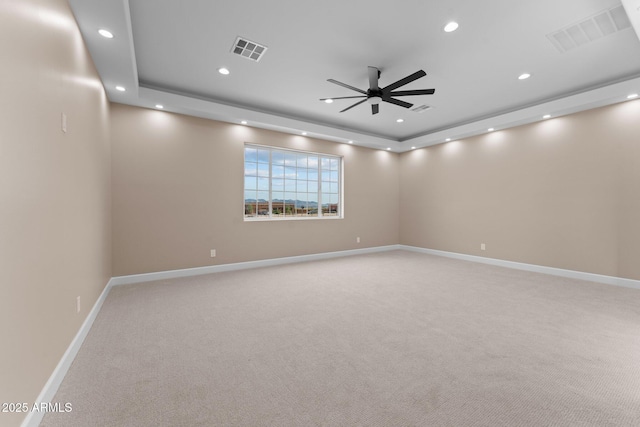 unfurnished room with ceiling fan, carpet, and a raised ceiling