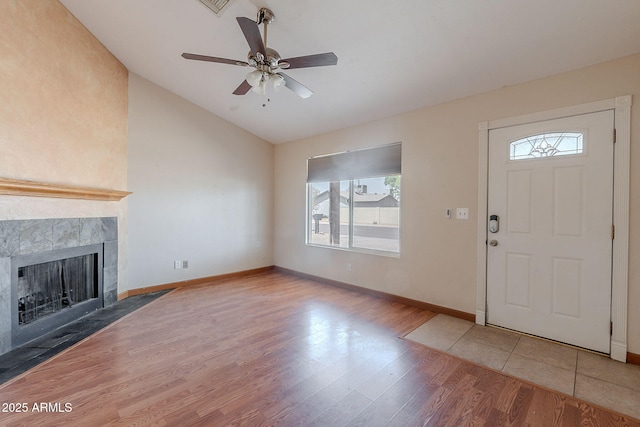 12613 N 51st Dr, Glendale, AZ 85304 - entryway with lofted ceiling, healthy amount of natural light, wood finished floors, a tile fireplace, and ceiling fan