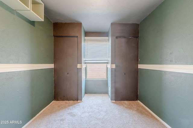 12613 N 51st Dr, Glendale, AZ 85304 - unfurnished bedroom featuring carpet floors, multiple closets, and baseboards