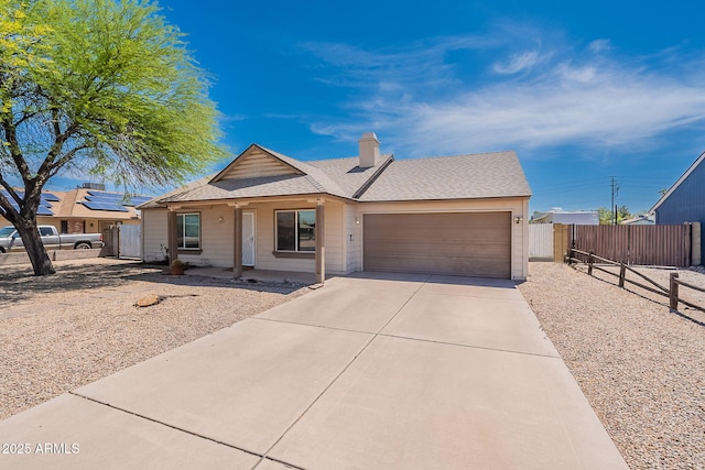 12613 N 51st Dr, Glendale, AZ 85304 - ranch-style home featuring an attached garage, concrete driveway, a shingled roof, covered porch, and a chimney