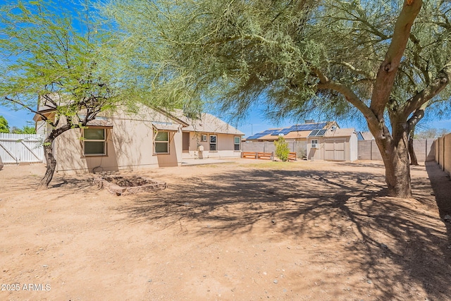 12613 N 51st Dr, Glendale, AZ 85304 - back of house featuring a fenced backyard and roof mounted solar panels