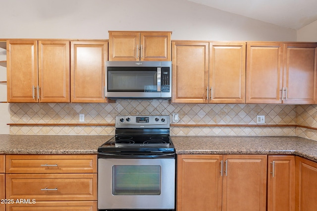 12613 N 51st Dr, Glendale, AZ 85304 - kitchen featuring appliances with stainless steel finishes, lofted ceiling, and decorative backsplash