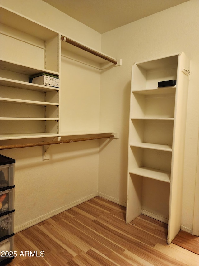 spacious closet featuring wood finished floors