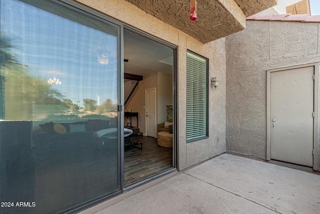 view of exterior entry with a patio