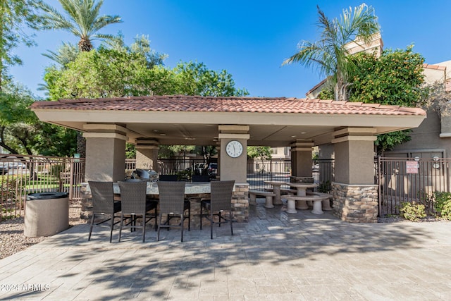 view of patio with a gazebo, area for grilling, and a bar