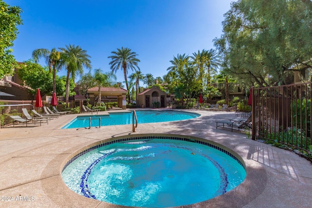 view of pool featuring a community hot tub and a patio