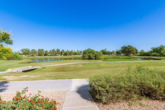 view of community with a lawn and a water view