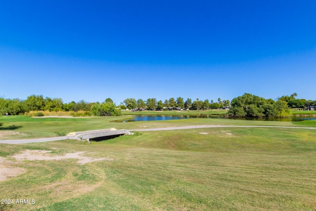 view of home's community with a yard and a water view