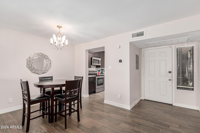 dining space featuring dark hardwood / wood-style flooring, a textured ceiling, electric panel, and an inviting chandelier