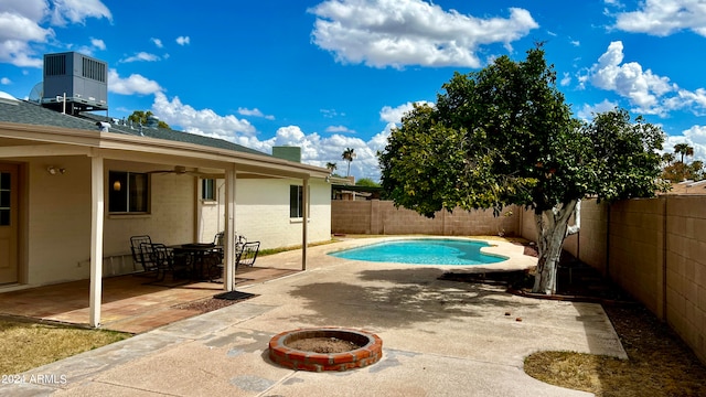 view of pool featuring ceiling fan, central AC unit, a patio area, and a fire pit