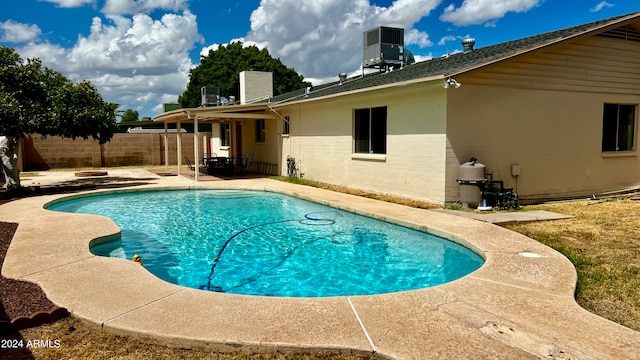 view of pool featuring central AC unit and a patio