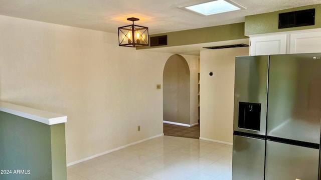 unfurnished room with a skylight