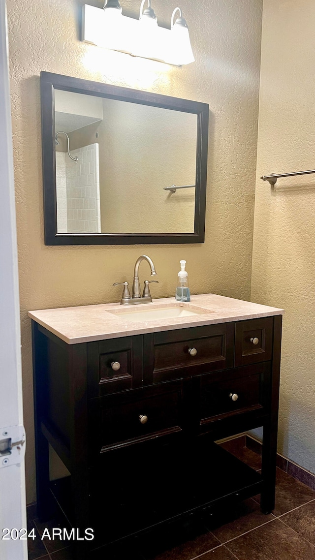 bathroom featuring tile patterned flooring and vanity