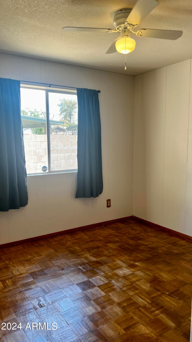 spare room with ceiling fan and a textured ceiling