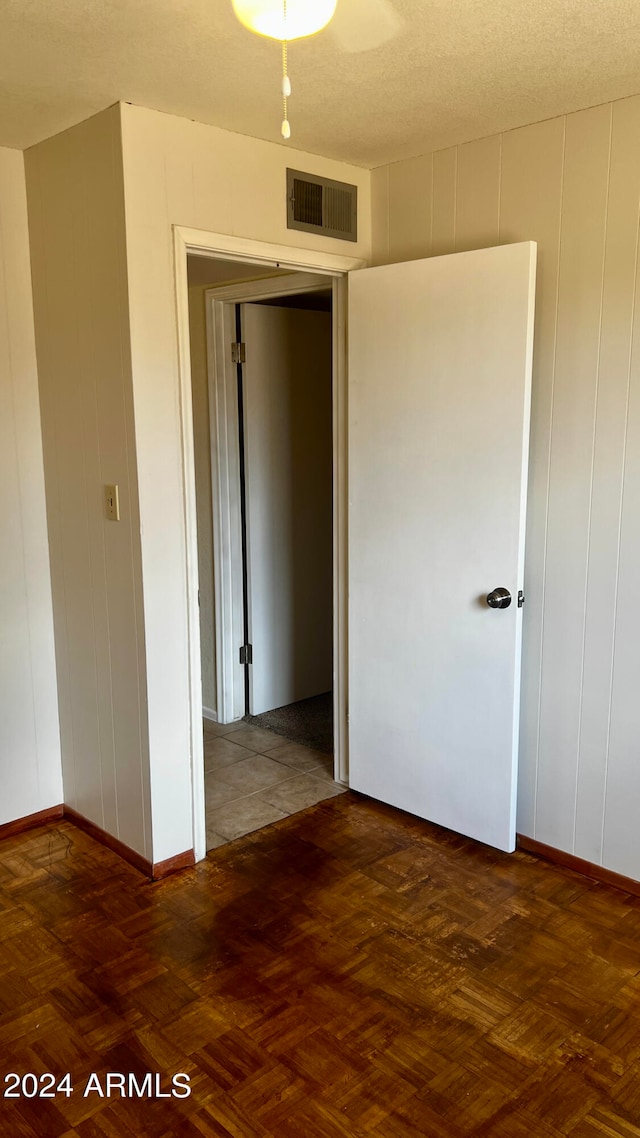 unfurnished room featuring a textured ceiling