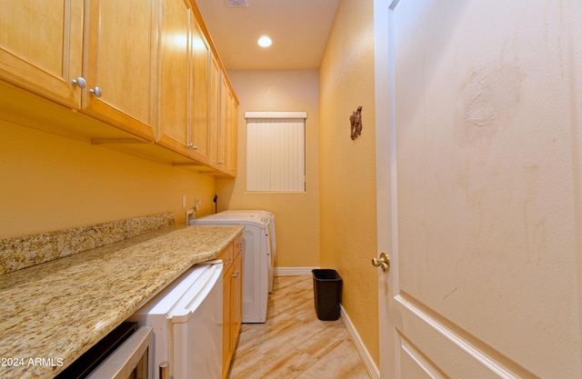 washroom with cabinet space, visible vents, light wood-style floors, washer and dryer, and baseboards