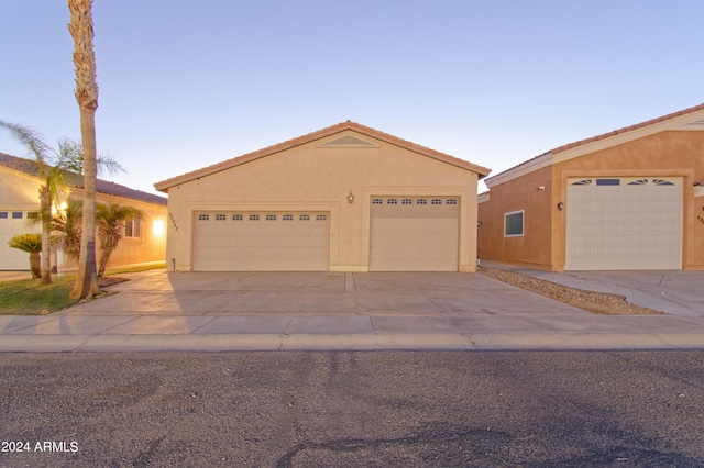 view of front facade with an outbuilding and stucco siding