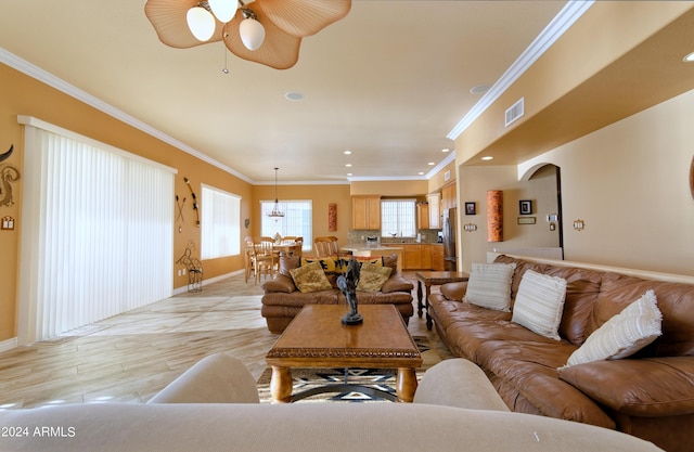 living room featuring recessed lighting, visible vents, light wood-style flooring, ornamental molding, and baseboards