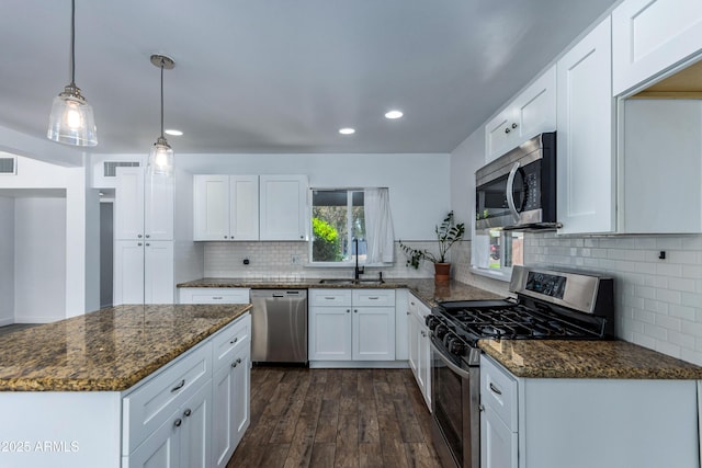 1334 W Sells Dr, Phoenix, AZ 85013 - kitchen featuring stainless steel appliances, a sink, dark wood finished floors, dark stone counters, and recessed lighting