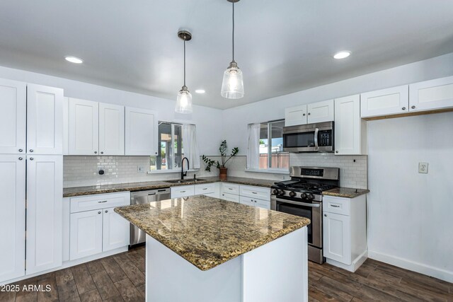 1334 W Sells Dr, Phoenix, AZ 85013 - kitchen with appliances with stainless steel finishes, a sink, dark wood finished floors, dark stone countertops, and recessed lighting