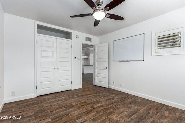 1334 W Sells Dr, Phoenix, AZ 85013 - unfurnished bedroom featuring baseboards, dark wood-type flooring, a closet, and ceiling fan