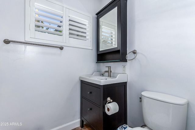 1334 W Sells Dr, Phoenix, AZ 85013 - bathroom featuring toilet, vanity, and healthy amount of natural light