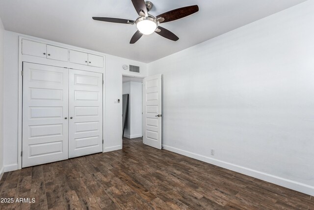 1334 W Sells Dr, Phoenix, AZ 85013 - unfurnished bedroom with baseboards, dark wood-type flooring, a closet, and a ceiling fan