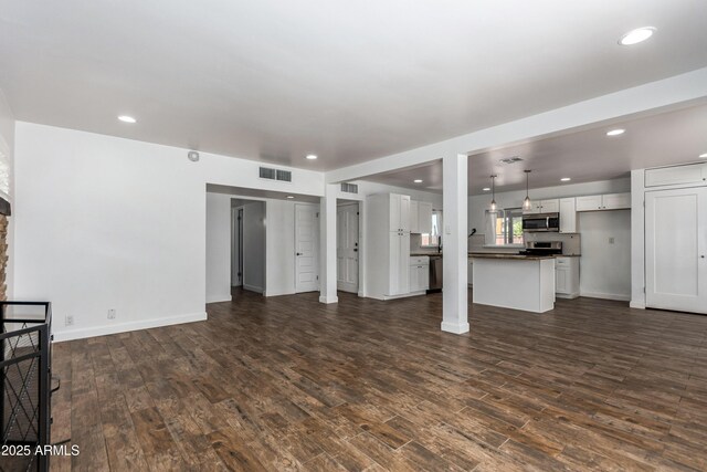 1334 W Sells Dr, Phoenix, AZ 85013 - unfurnished living room with dark wood-style floors, recessed lighting, and baseboards