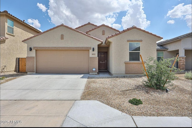 16955 W Butler Ave, Waddell, AZ 85355 - mediterranean / spanish house with stucco siding, driveway, an attached garage, and a tile roof