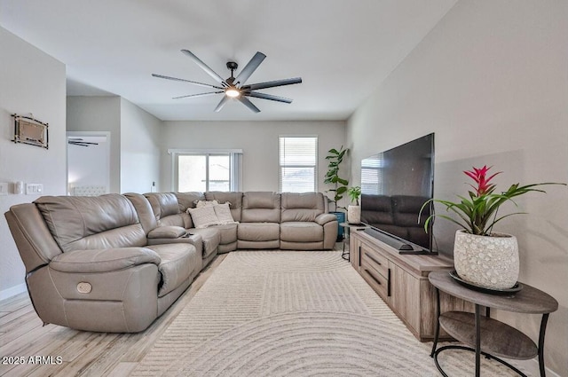 16955 W Butler Ave, Waddell, AZ 85355 - living room with a ceiling fan, light wood-style floors, and baseboards