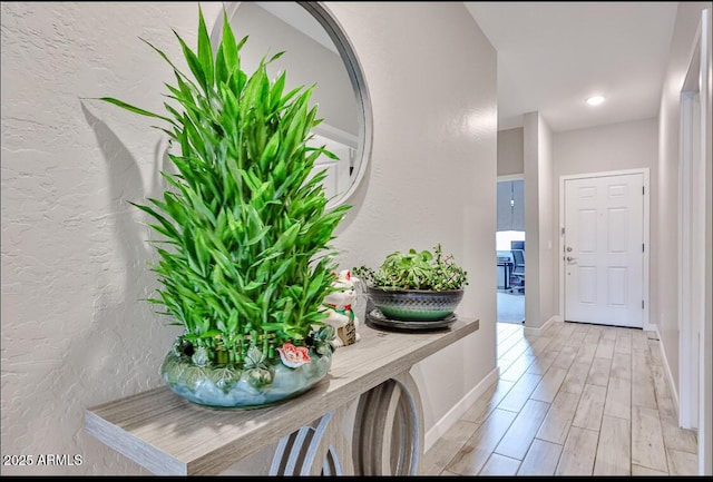 16955 W Butler Ave, Waddell, AZ 85355 - hallway featuring a textured wall, baseboards, and light wood-style flooring
