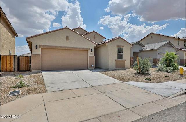 16955 W Butler Ave, Waddell, AZ 85355 - mediterranean / spanish house featuring stucco siding, driveway, an attached garage, and a gate