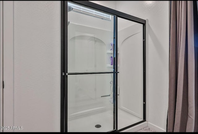 16955 W Butler Ave, Waddell, AZ 85355 - bathroom with a textured wall and a stall shower