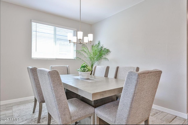 16955 W Butler Ave, Waddell, AZ 85355 - dining room featuring wood finished floors, a chandelier, and baseboards