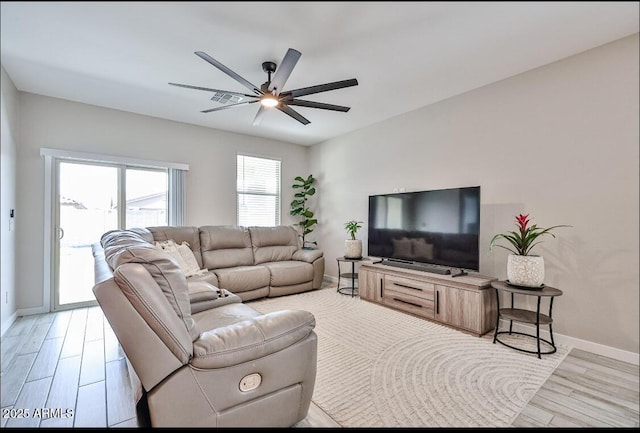 16955 W Butler Ave, Waddell, AZ 85355 - living room with a ceiling fan, baseboards, and light wood-type flooring