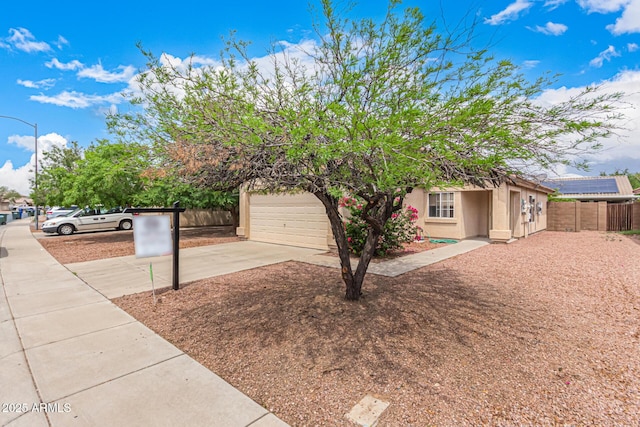 12132 W Dahlia Dr, El Mirage, AZ 85335 - view of front of home featuring driveway, fence, stucco siding, and an attached garage