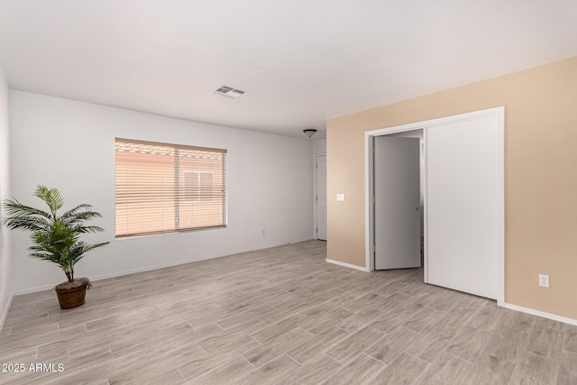12132 W Dahlia Dr, El Mirage, AZ 85335 - spare room featuring light wood-type flooring and baseboards