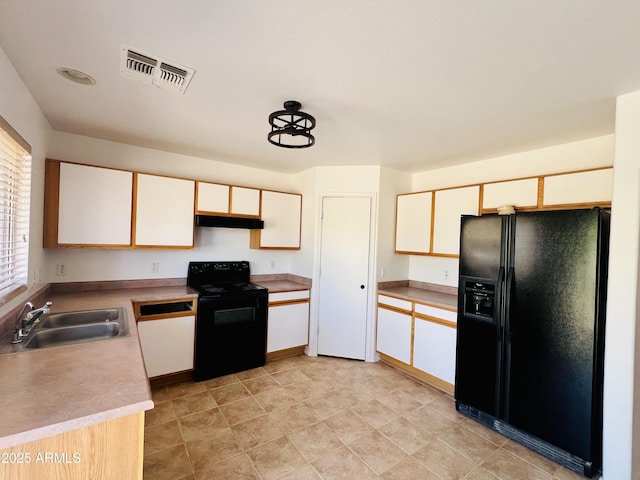 12132 W Dahlia Dr, El Mirage, AZ 85335 - kitchen with black appliances, under cabinet range hood, a sink, and light countertops