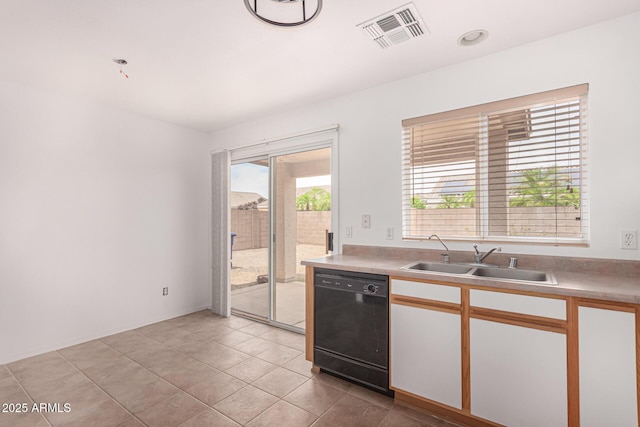 12132 W Dahlia Dr, El Mirage, AZ 85335 - kitchen with dishwasher, a sink, light tile patterned flooring, light countertops, and white cabinets
