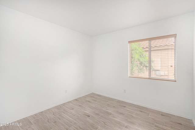 12132 W Dahlia Dr, El Mirage, AZ 85335 - unfurnished room featuring baseboards and light wood-type flooring