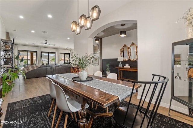20715 E Watford Dr, Queen Creek, AZ 85142 - dining space featuring arched walkways, wood finished floors, a ceiling fan, and recessed lighting