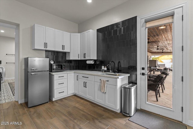 20715 E Watford Dr, Queen Creek, AZ 85142 - kitchen featuring appliances with stainless steel finishes, a sink, white cabinets, dark wood-type flooring, and light countertops
