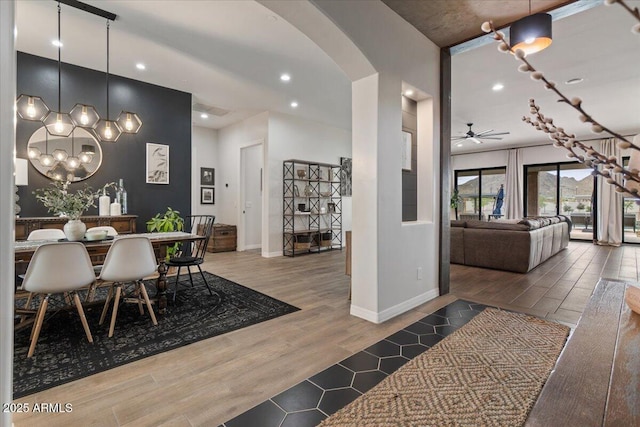 20715 E Watford Dr, Queen Creek, AZ 85142 - dining space with arched walkways, wood finished floors, baseboards, ceiling fan, and recessed lighting